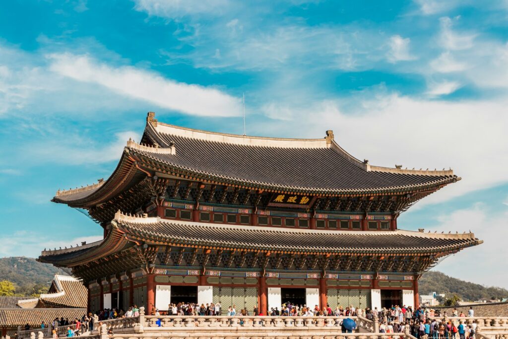 Gyeongbokgung Palace under a bright blue sky in Seoul.