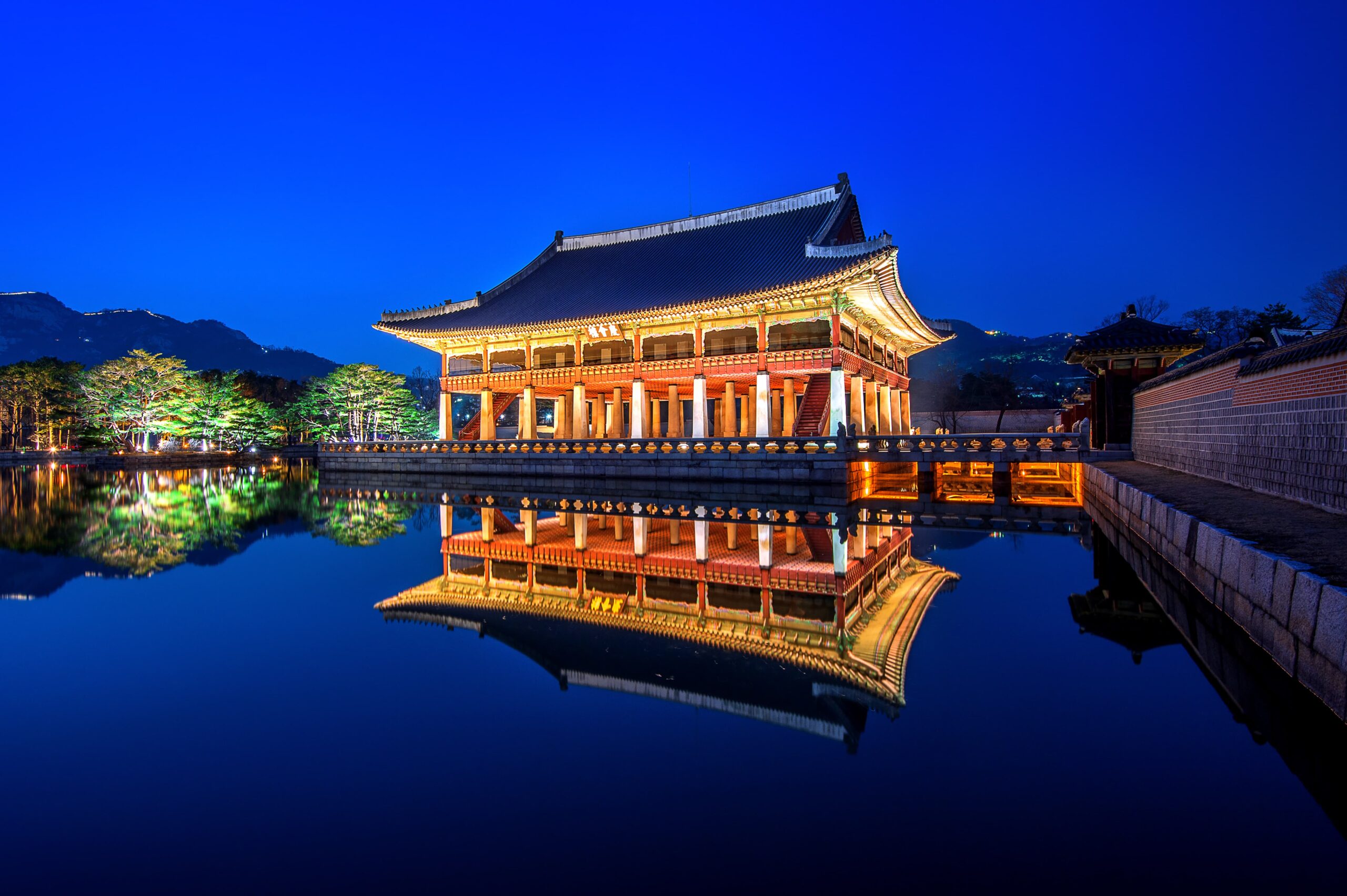 Gyeongbokgung Palace illuminated at night in Seoul.